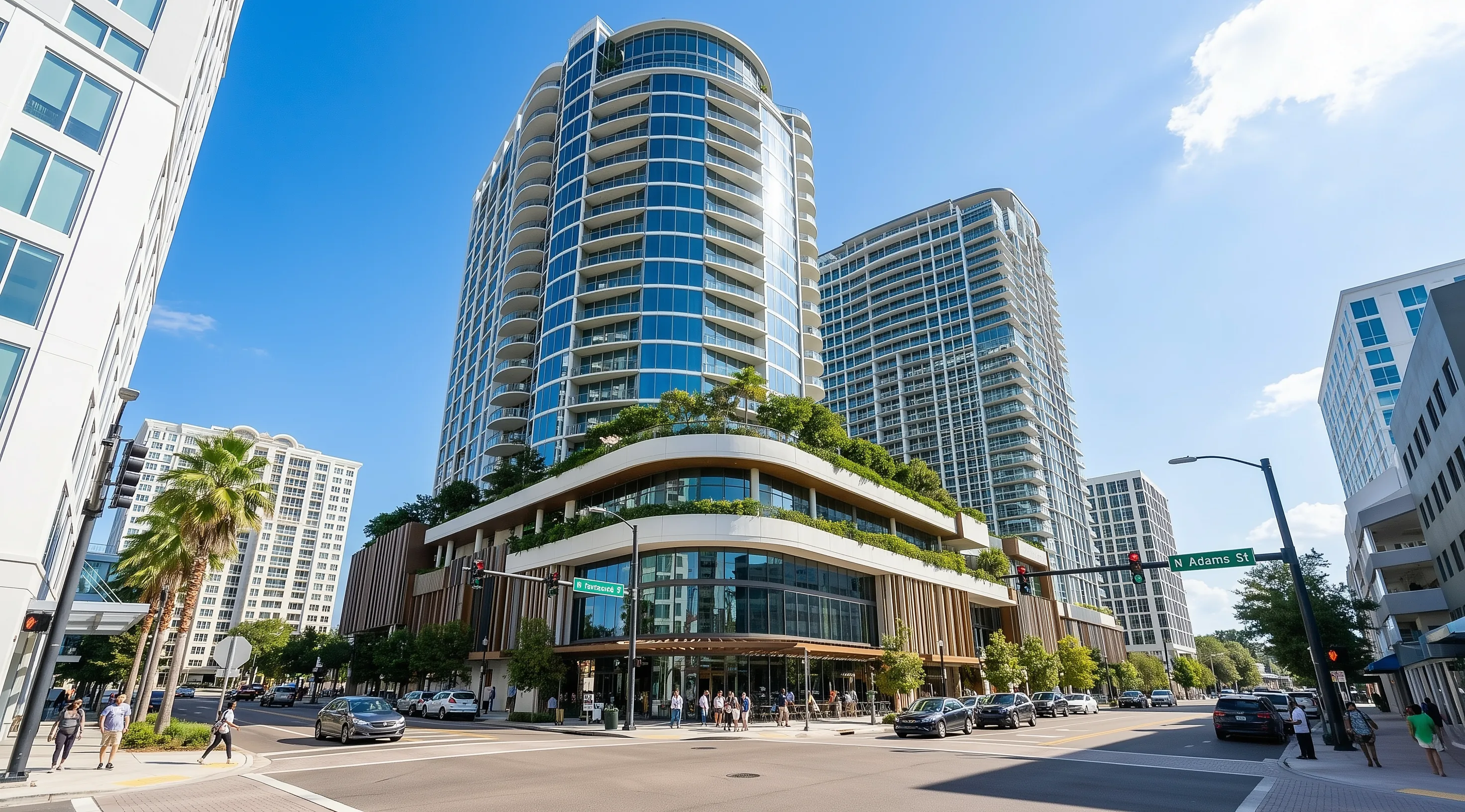 A modern mixed-use hotel tower rising above a downtown streetscape